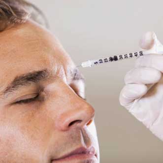 Man receiving an injectable botox at orthodontist office.